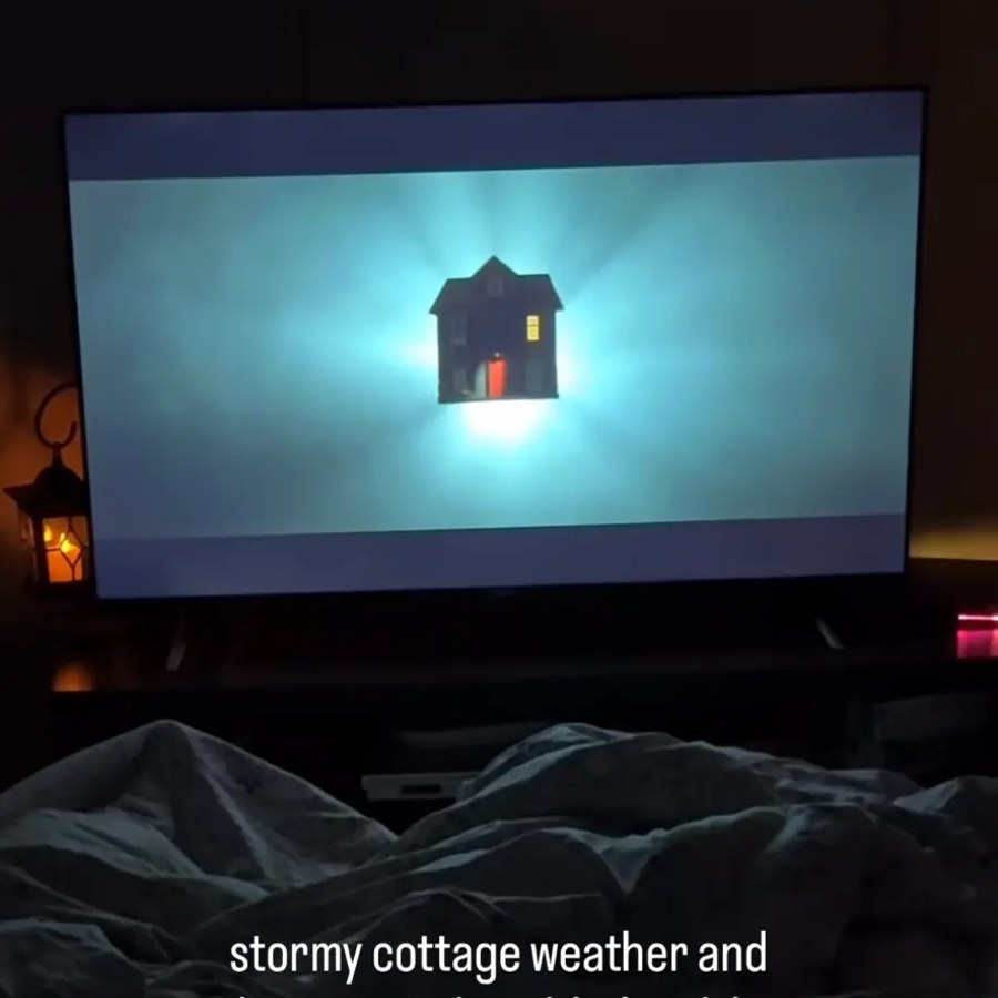Stormy cottage night with a movie on and a lantern glowing